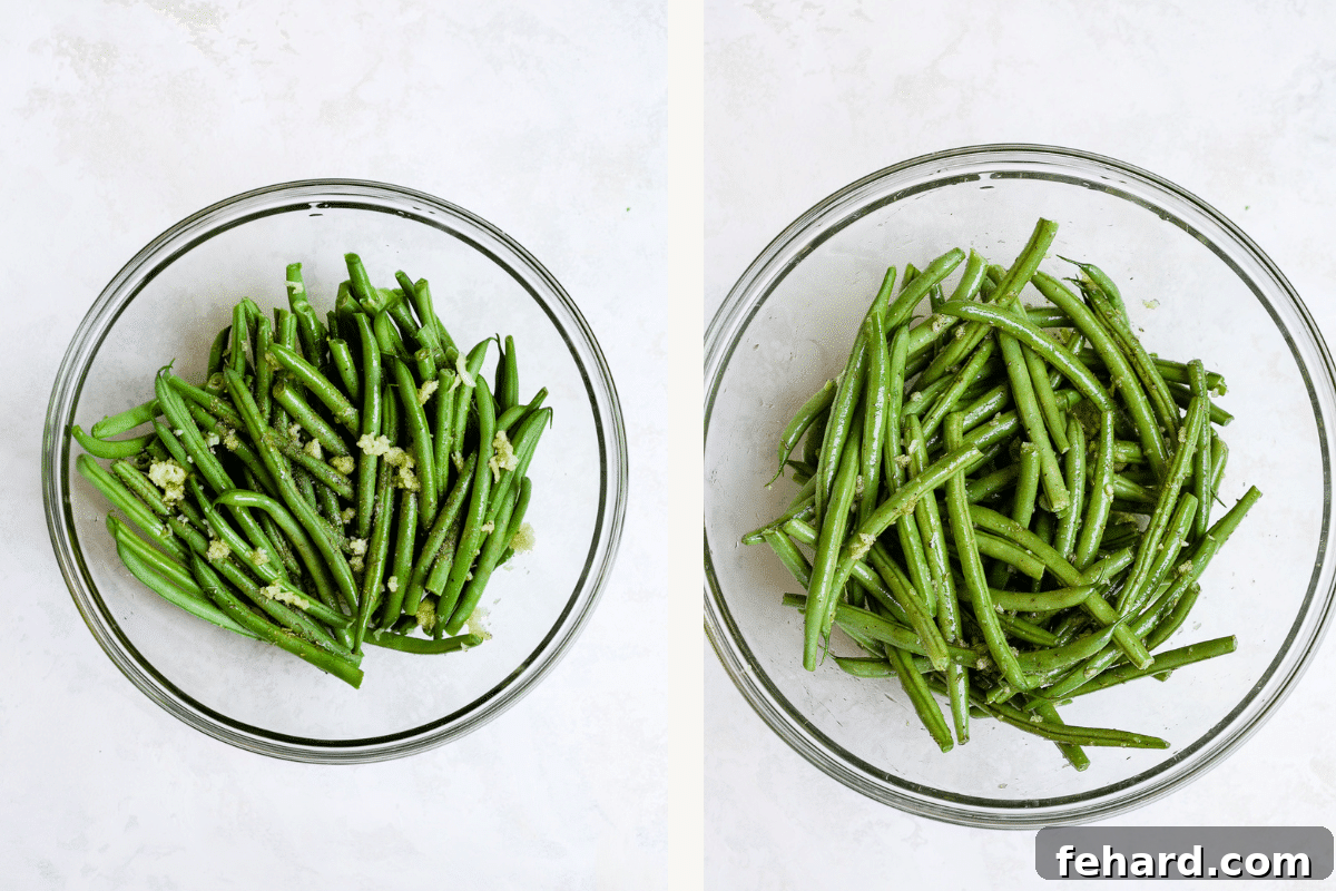Green beans being seasoned in a large mixing bowl, coated with olive oil and spices.
