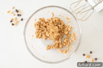 Creamy peanut butter egg filling being mixed in a large bowl with an electric mixer.