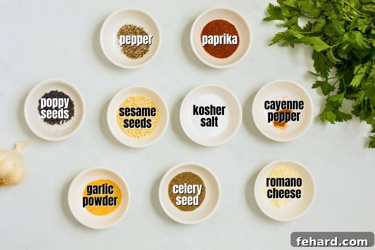 Essential Ingredients for Salad Supreme Seasoning Individual ingredients for Homemade Salad Supreme Seasoning, including sesame seeds, poppy seeds, paprika, celery seed, salt, pepper, cayenne pepper, and Romano cheese, meticulously arranged in small labeled bowls for clarity.