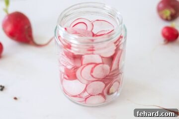 Jar filled with thinly sliced radishes.