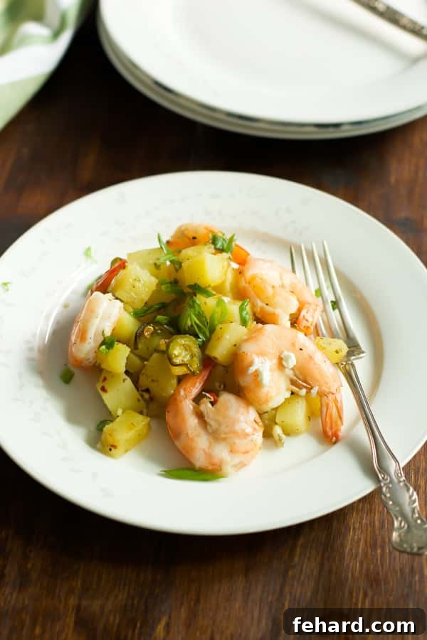 baked potato with lemon shrimp on a plate