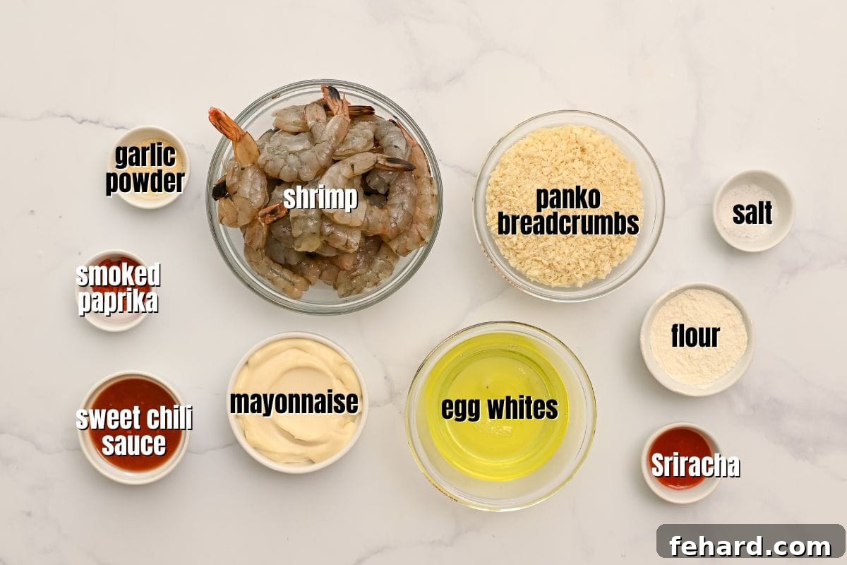 Arrangement of all key ingredients for homemade Bang Bang Shrimp and Bang Bang Sauce in small bowls on a kitchen counter, highlighting freshness and variety.