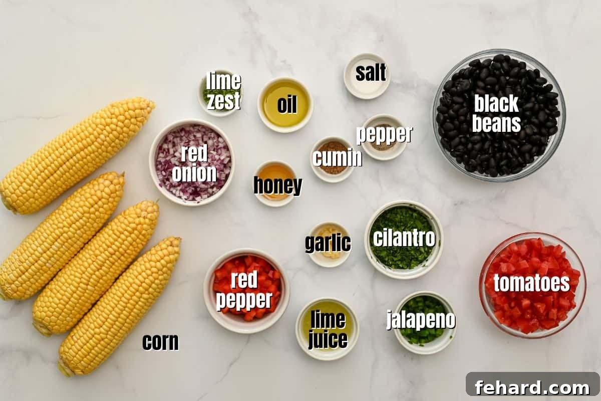 A flat lay photograph showcasing all the fresh ingredients needed for black bean and corn salsa, neatly arranged on a kitchen counter.