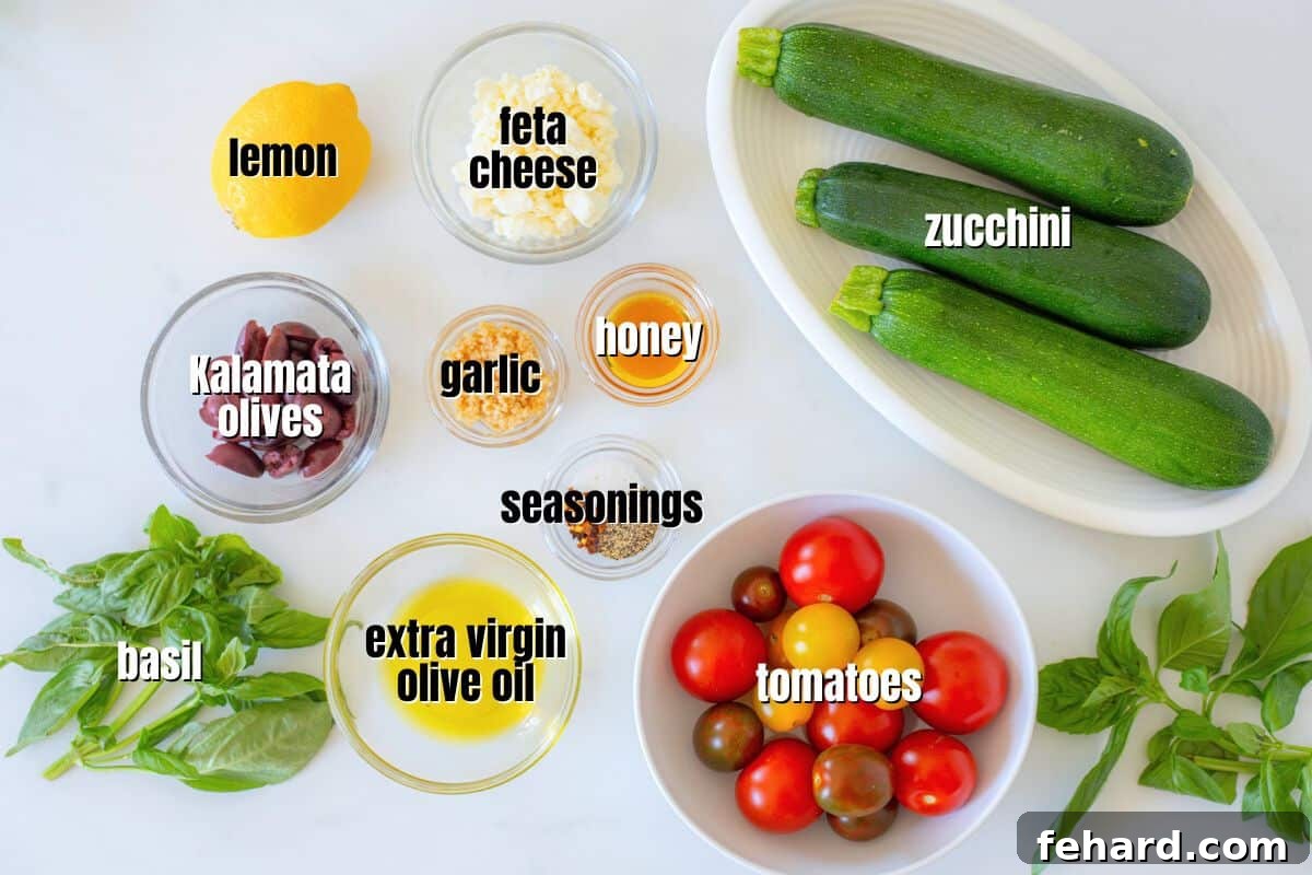 Easy Zucchini Salad Recipe Ingredients A selection of fresh zucchini salad ingredients artfully arranged on a kitchen counter, including sliced zucchini, whole tomatoes, Kalamata olives, fresh basil, and lemon, ready for preparation.