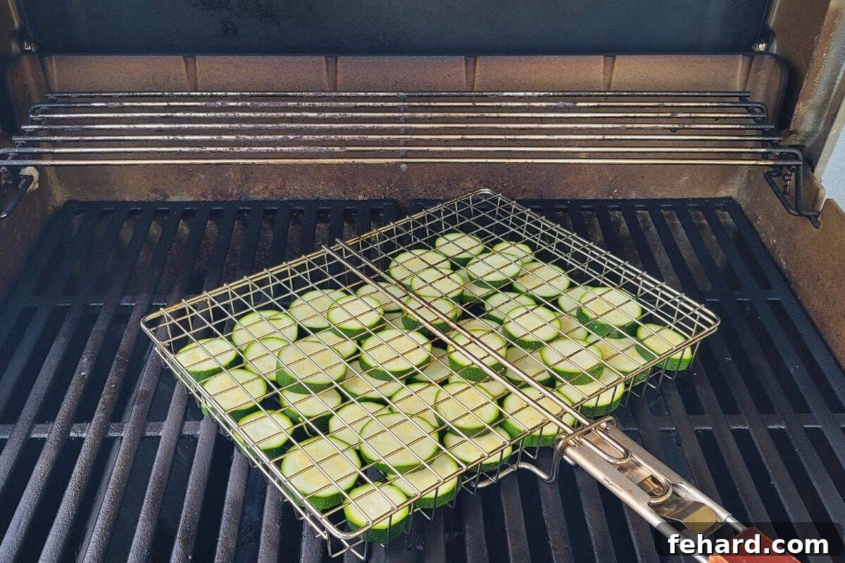 Grilling Zucchini in a Basket Sliced zucchini arranged neatly in a metal grill basket, positioned over the flames of a gas grill, cooking to tender perfection.