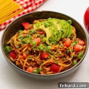 Fiesta Spaghetti 4 Bowl of Mexican Spaghetti topped with cilantro, avocado, and diced tomatoes.