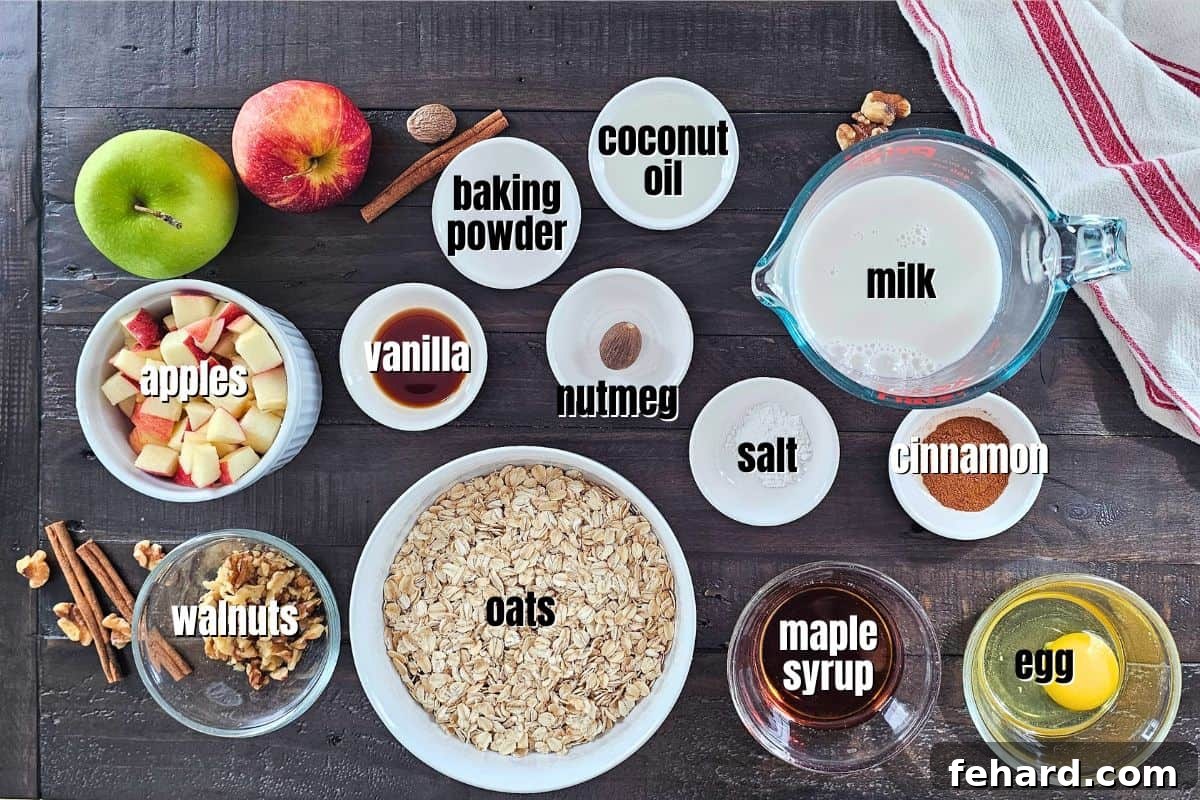Ingredients for baked apple oatmeal laid out on a kitchen counter, featuring rolled oats, fresh apples, and spices.