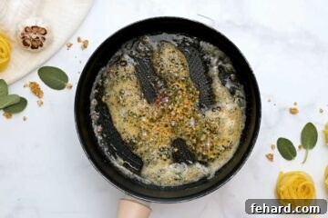 Skillet with lightly golden brown butter, sage, crushed red pepper flakes and garlic.