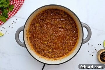 Taco meat simmered in large soup pan for base of taco soup.