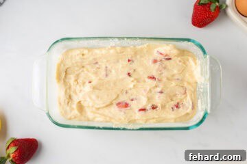 Batter for fresh strawberry bread in glass baking dish.