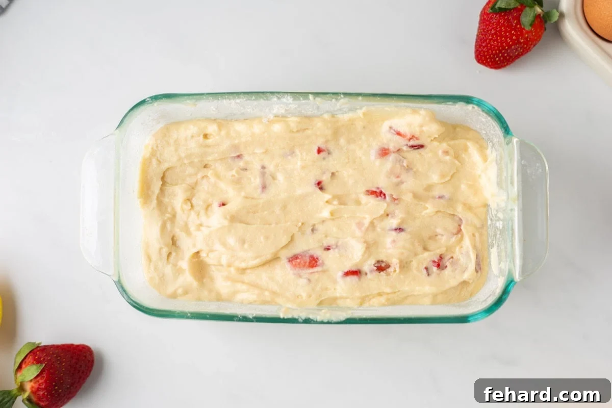 Batter for fresh strawberry bread in glass baking dish.