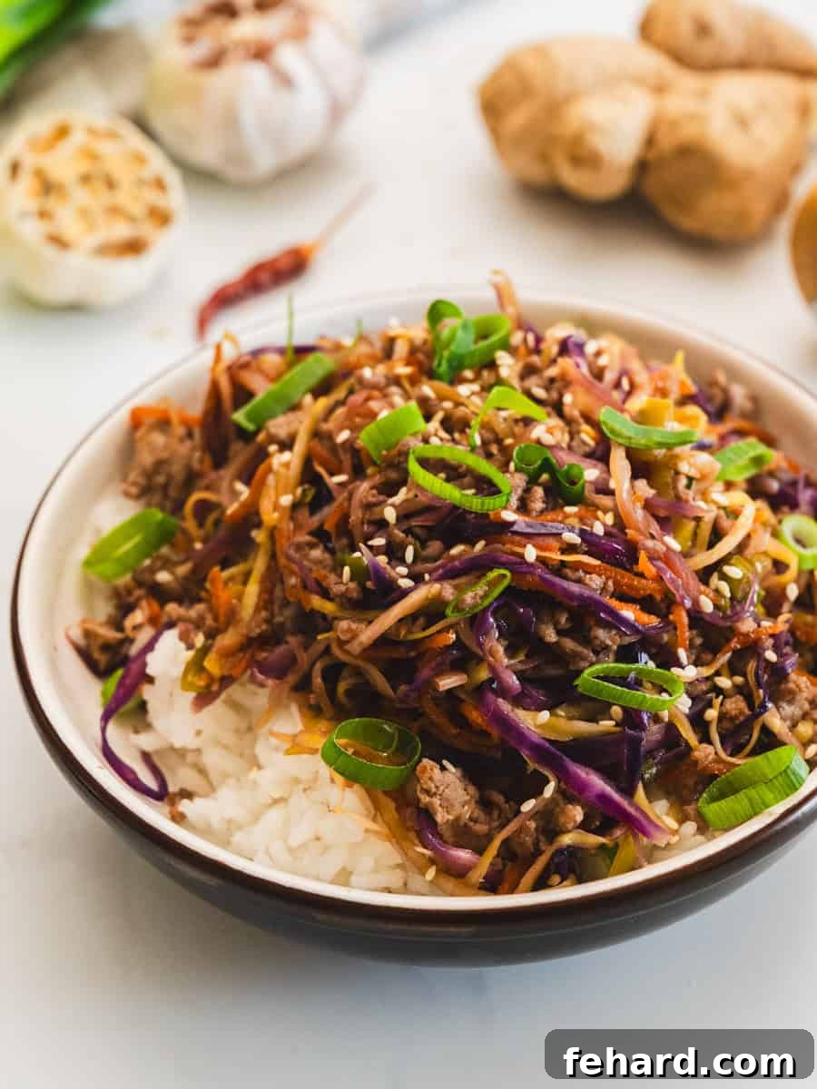 Egg Roll in a Bowl with Ground Turkey Browned turkey with coleslaw mix and egg roll sauce served over steamed white rice with sesame seeds and green onions.