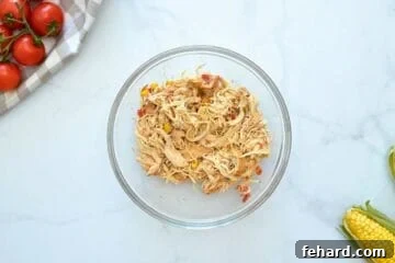 Shredded CHicken in bowl after being slow cooked in crockpot for chicken tortilla soup.