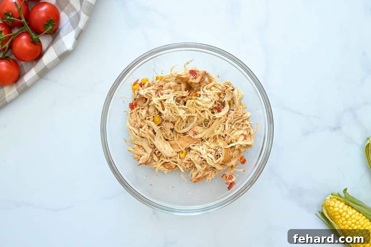 Shredded CHicken in bowl after being slow cooked in crockpot for chicken tortilla soup.