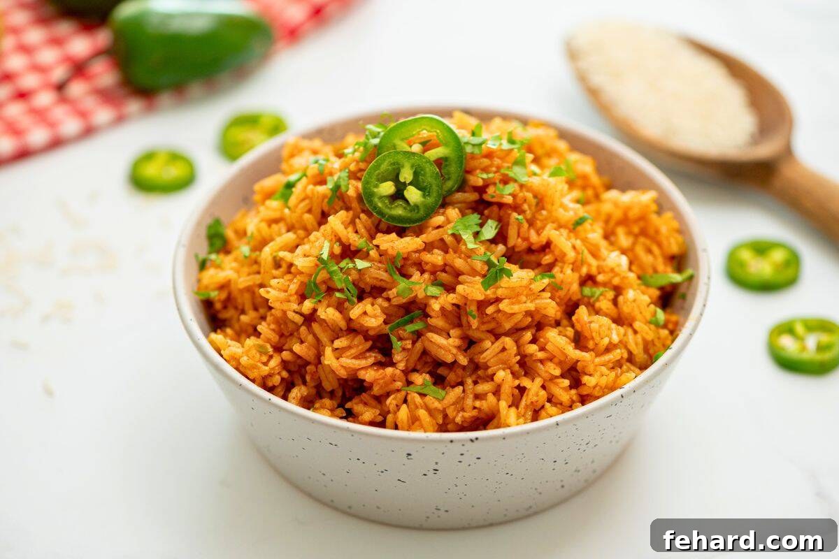 Perfectly cooked and seasoned Instant Pot Spanish rice fluffed and dished out in serving bowl.