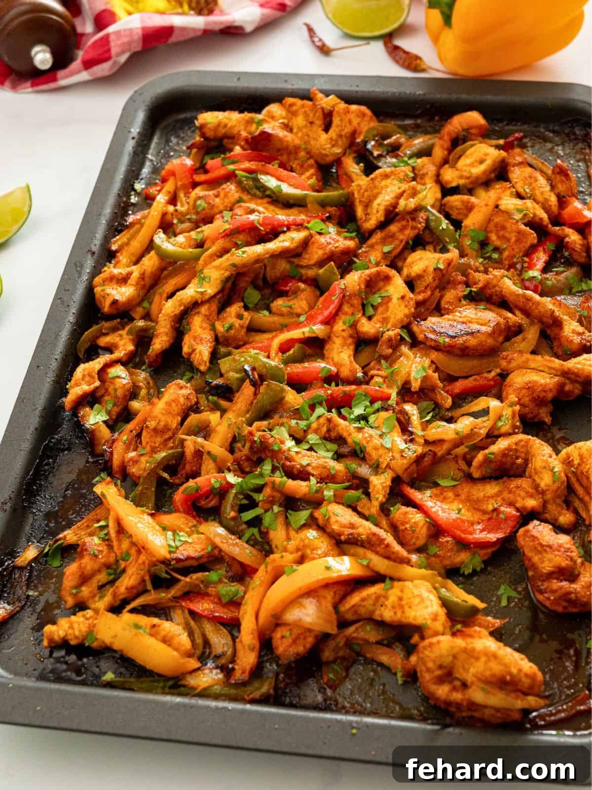 Delicious sheet pan chicken fajitas with colorful peppers, onions, and fresh cilantro, topped with lime zest. A vibrant and easy weeknight dinner idea.