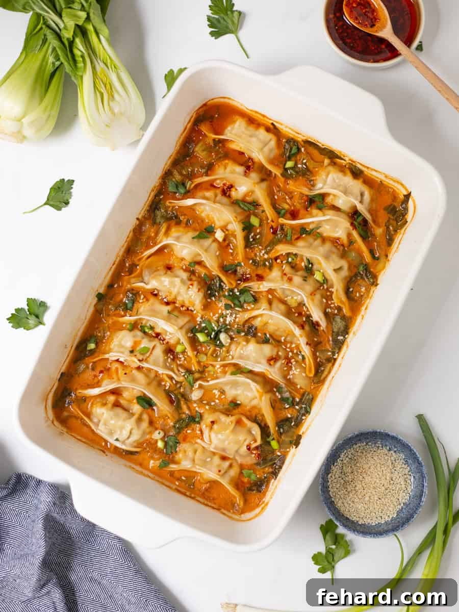 Frozen Goya Dumplings baked in curry-soy coconut broth with sliced bok choy topped with chili crisp, green onions, and sesame seeds.
