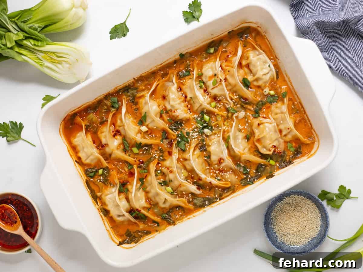 Frozen Goya Dumplings baked in curry-soy coconut broth with sliced bok choy topped with chili crisp, green onions, and sesame seeds.