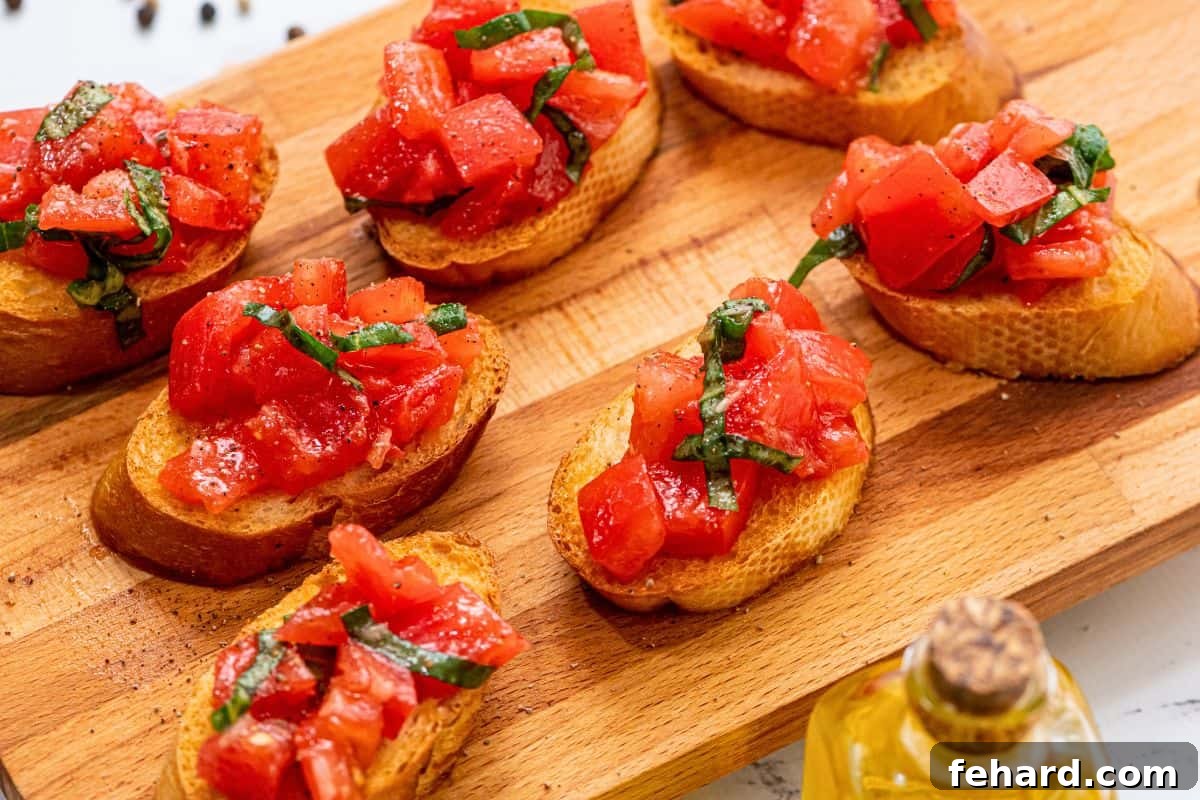 Bruschetta on wooden cutting board topped with tomatoes and basil.