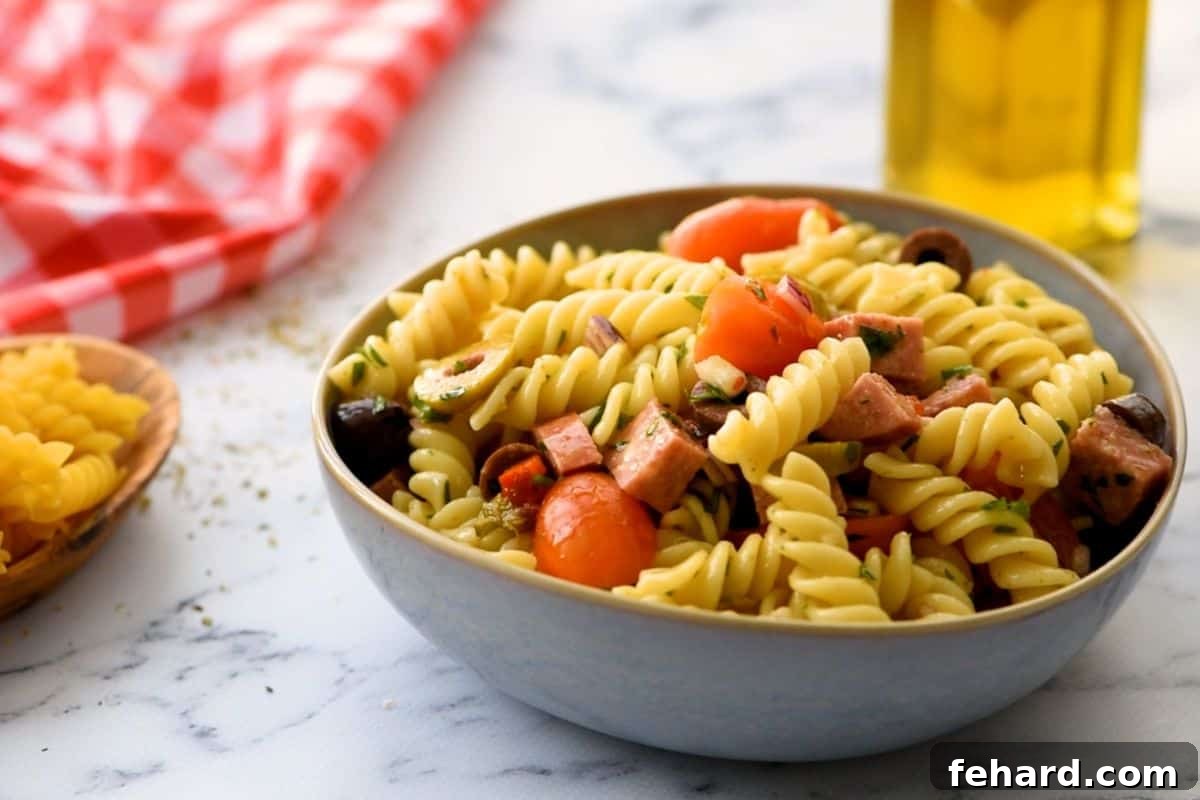 Close up of Antipasto Pasta Salad with tomatoes, onions, and pepperoni.