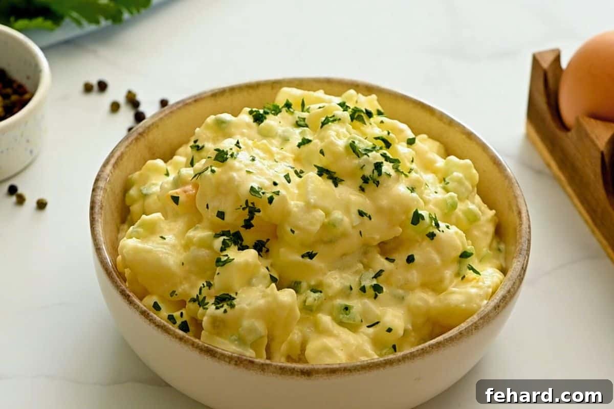 Hellmann's Potato Salad in large serving bowl topped with fresh parsley.
