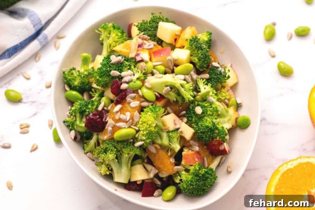 Fresh broccoli, apples, and oranges tossed together with orange juice dressing for light and refreshing summer salad.