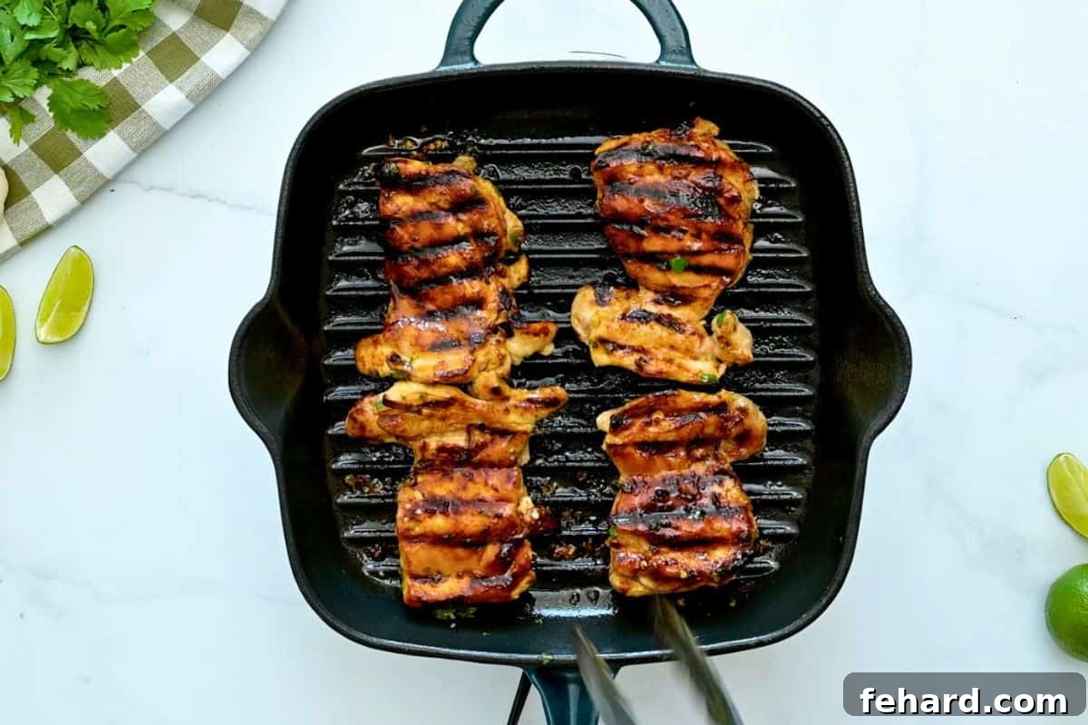 Grilled chicken thighs marinated in cilantro lime marinade on grill pan.