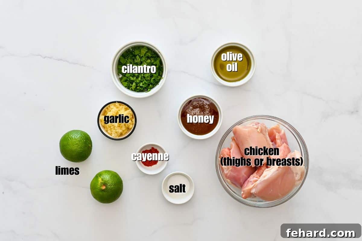 Chicken thighs, honey, limes, olive oil, garlic, salt, and cayenne labeled on counter.