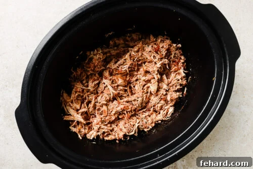 Slow Cooker Shredded Chicken Tacos with Flavorful Salsa 14 sheredded chicken inside the slow cooker