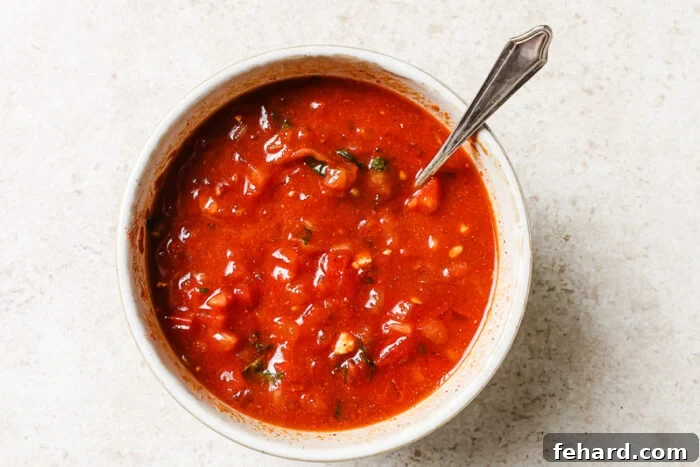 Slow Cooker Shredded Chicken Tacos with Flavorful Salsa 5 Tomato sauce blended with herbs and spices in a white bowl, ready to cook.