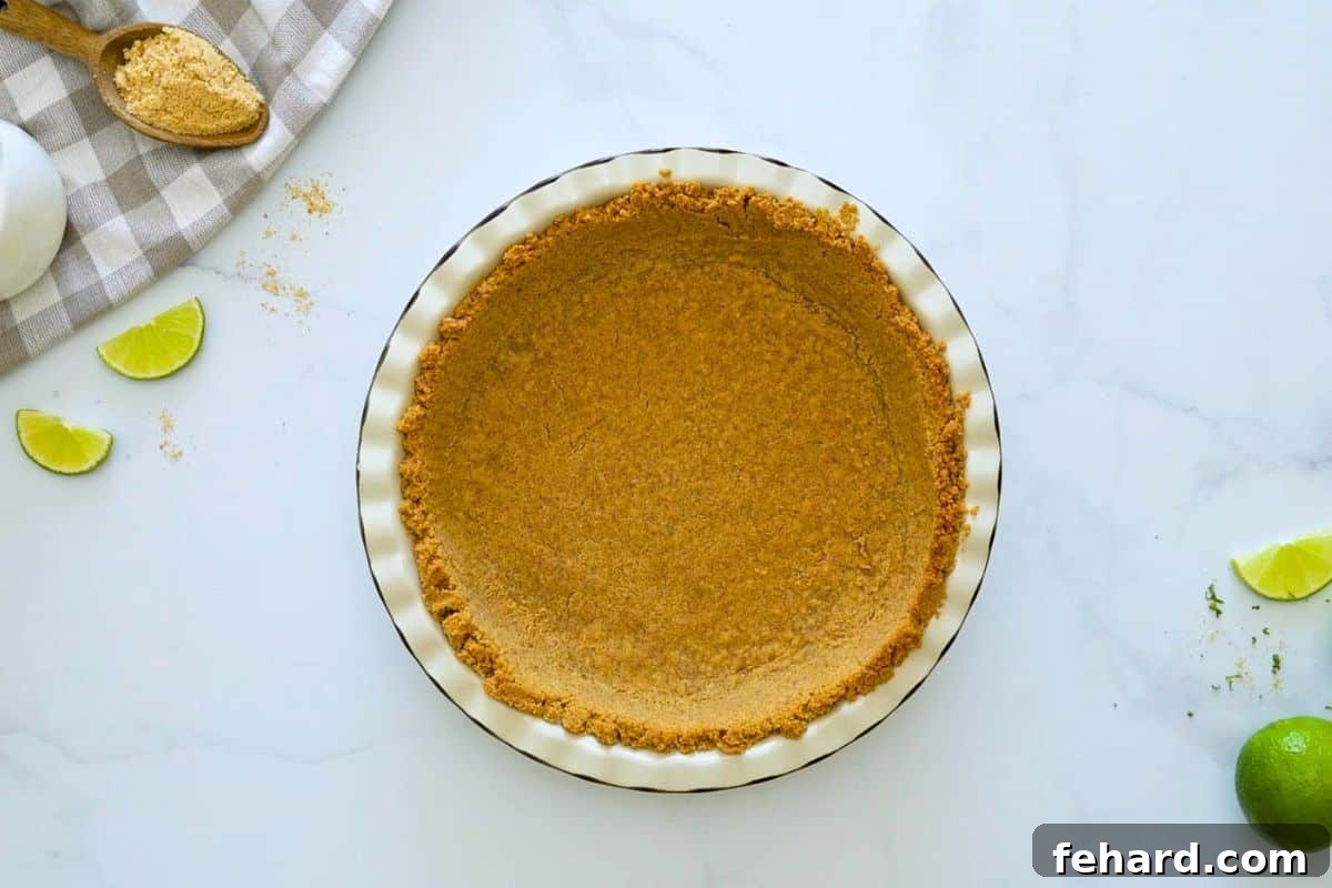 No Bake Key Lime Pie with Graham Cracker Crust Baked homemade graham cracker crust in pie plate.