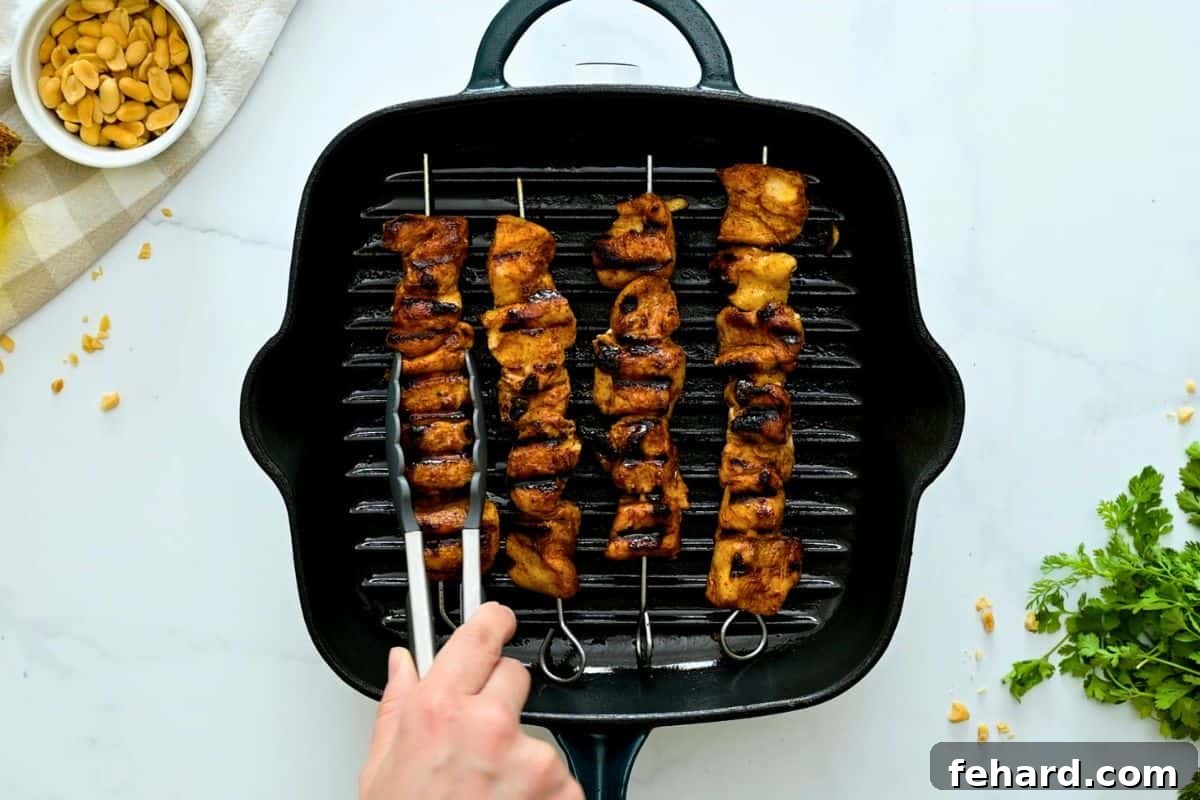 Chicken Kabobs Grilled Chicken Kabobs on metal skewers on grill plate.
