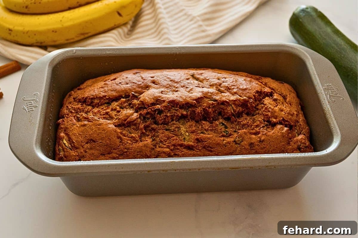 Whole-Wheat-Banana-Zucchini-Bread Baked zucchini banana bread in metal loaf pan.