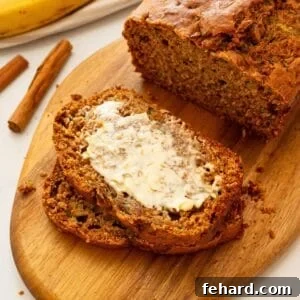 Moist Zucchini Banana Bread Recipe 3 Loaf of Zucchini Banana Bread sliced into thick slices showing one slice with smear of butter.