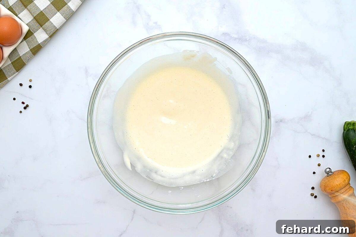 Easy Savory Zucchini Pie Recipe Flour, milk, baking powder, and salt mixed together in a large mixing bowl.