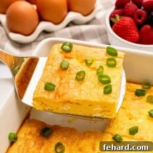 Baked Eggs with Cottage Cheese for Breakfast 3 Slice of baked cottage cheese egg being lifted by spatula from casserole dish showing fluffy eggs with a few small curds of cottage cheese.