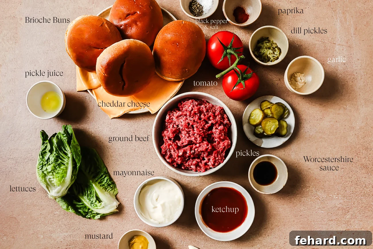 A flat lay of Smash Burger Recipe ingredients including brioche buns, cheddar cheese, tomato, ground beef, pickles, lettuce, mayonnaise, mustard, ketchup, Worcestershire sauce, garlic, dill pickles, pickle juice, and seasonings.