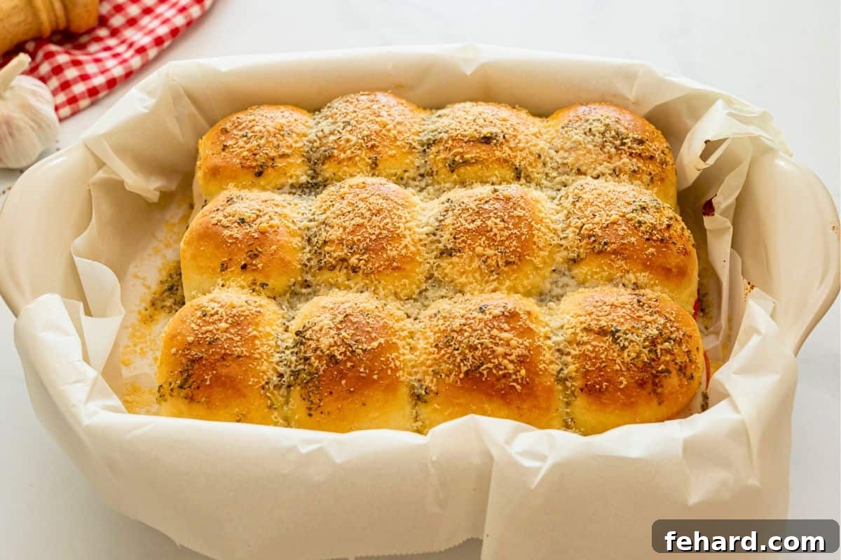 Lightly golden pizza sliders after baking in baking dish lined with parchment paper.