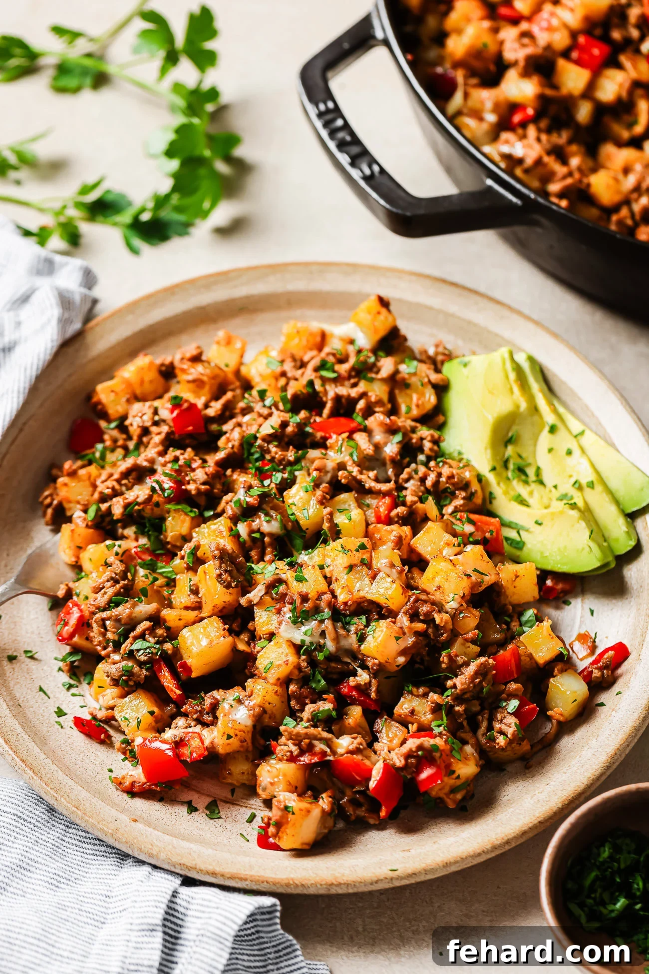 Close-up of ground beef and potatoes on a plate.