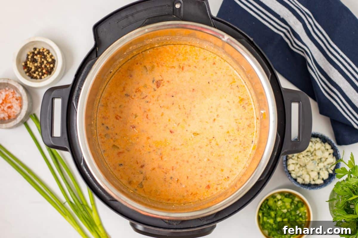 Cream cheese whisked into buffalo chicken chili until melted and creamy.