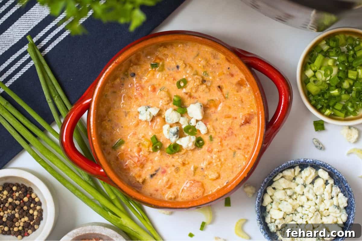 Bowl of creamy Instant Pot Buffalo Chicken Chili made with cream cheese and topped the blue cheese.