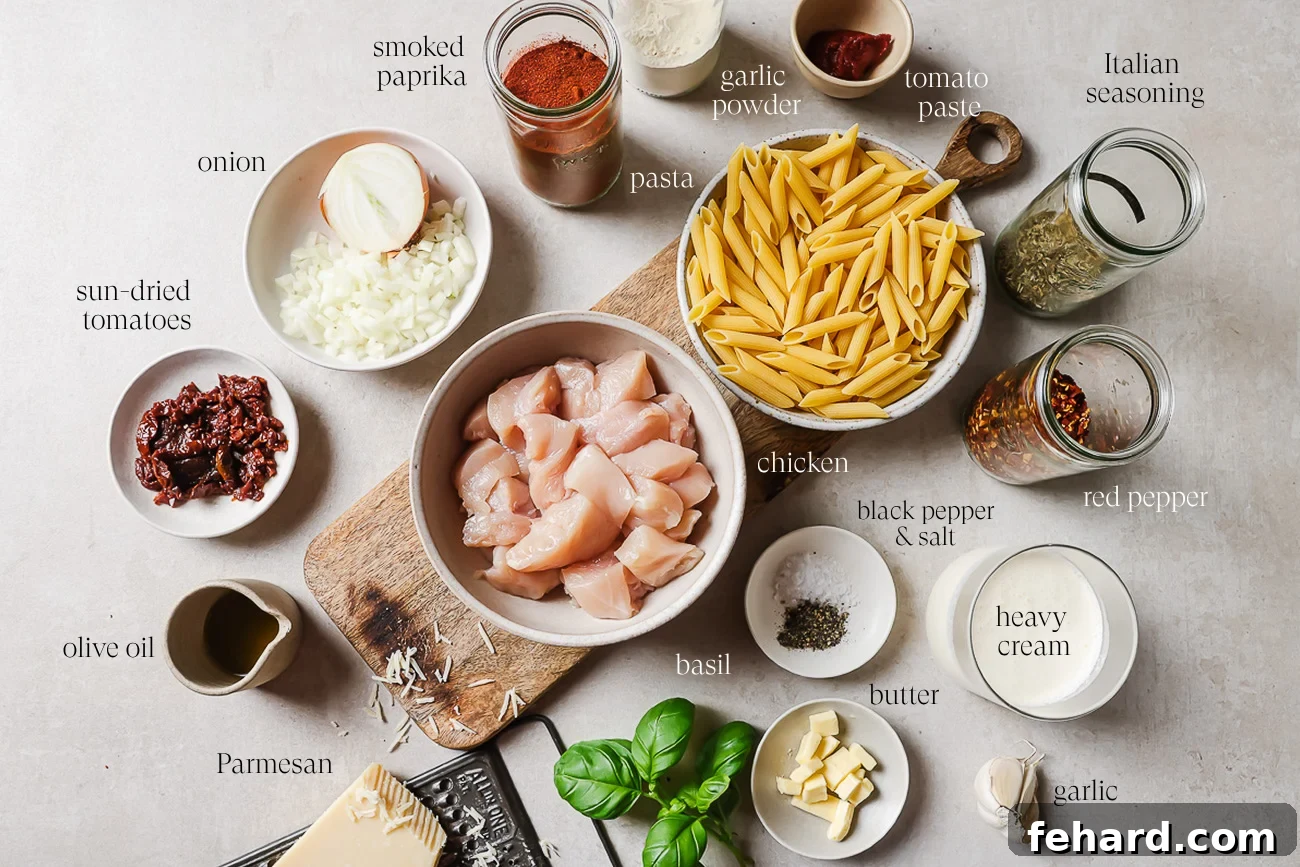 Ingredients for a Marry Me Chicken Pasta are arranged on a counter, including diced chicken, penne, cream, parmesan, herbs, spices, sun-dried tomatoes, onion, olive oil, butter, and garlic. Labels identify each ingredient.